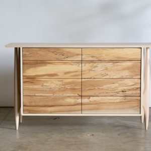 Maple dresser with eight drawers. Legs are artfully shaped and exposed on the outside of the case of drawers.
