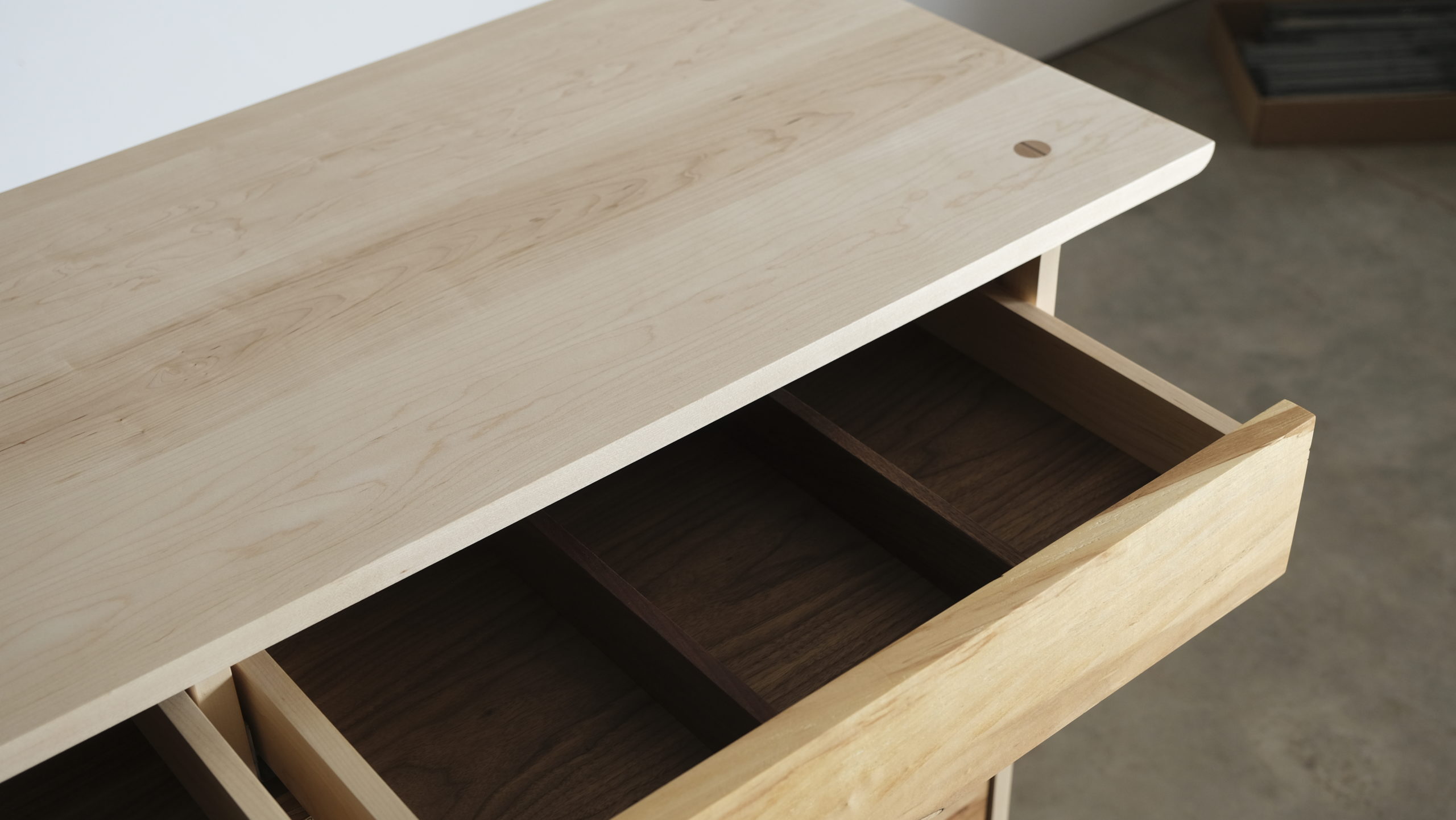 An open dresser drawer divided into three sections.