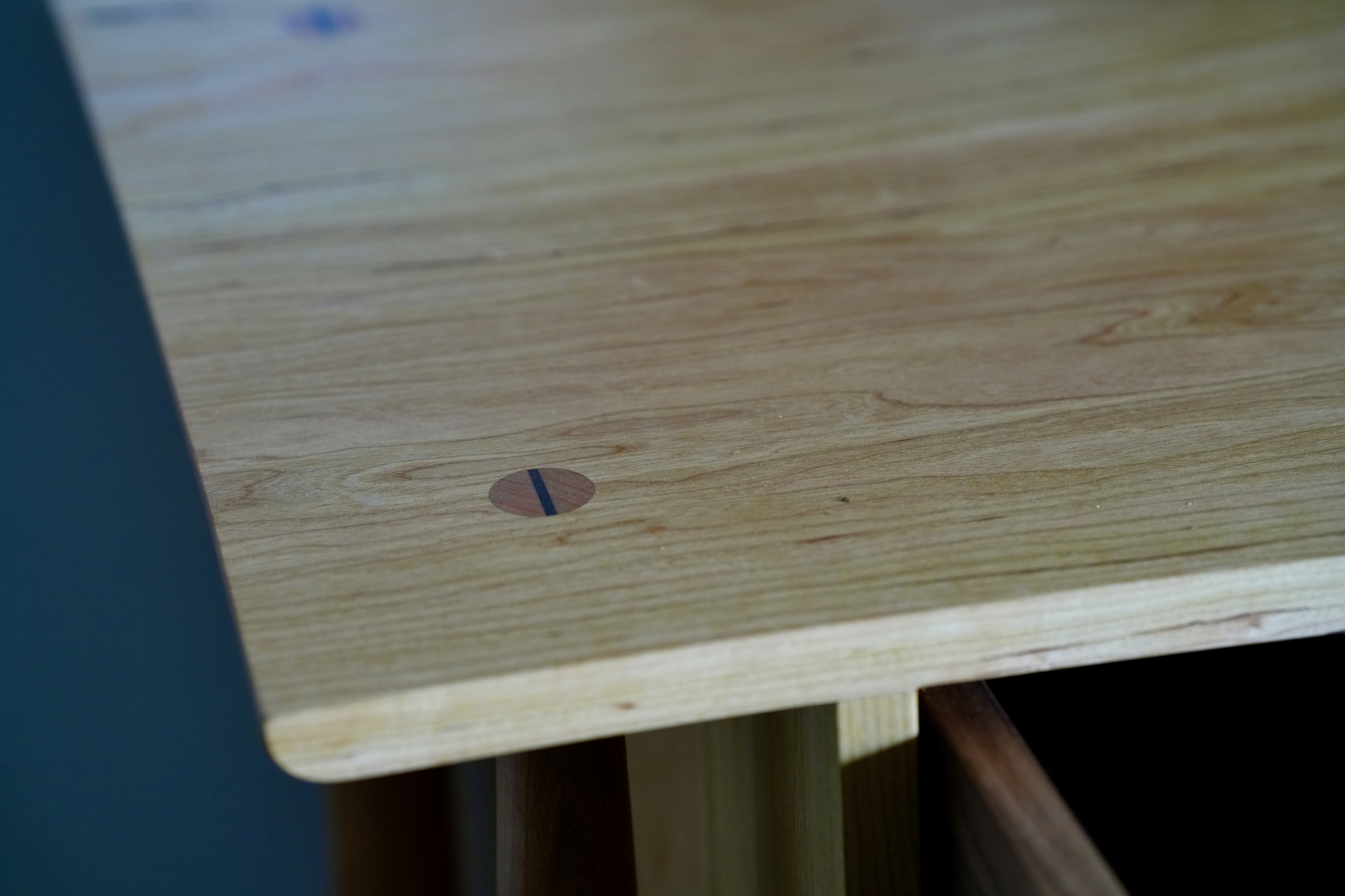 A close-up of the top of a midcentury modern dresser in cherry