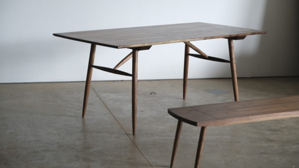 A walnut dining table and bench