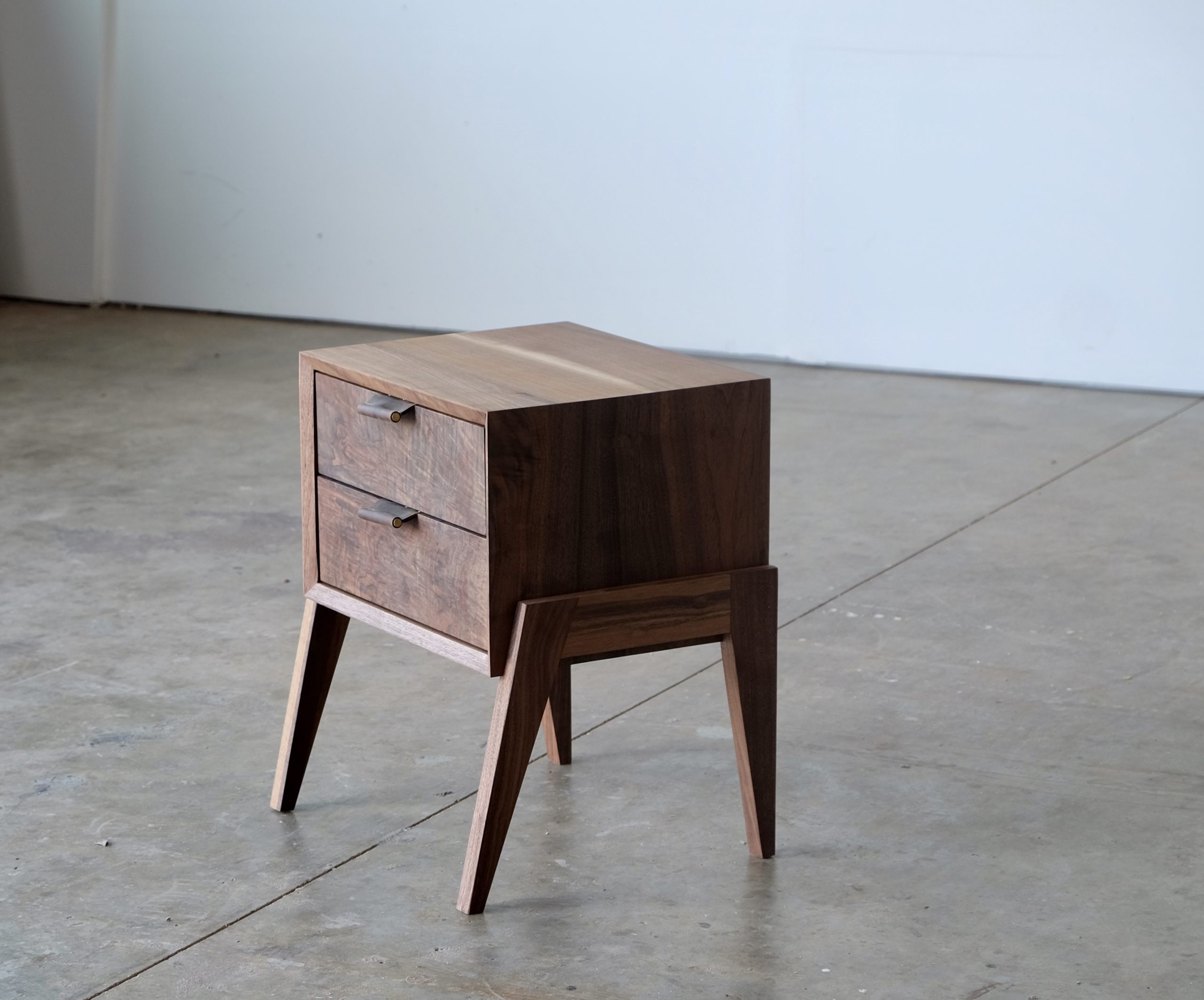 A two drawer nightstand made of solid walnut